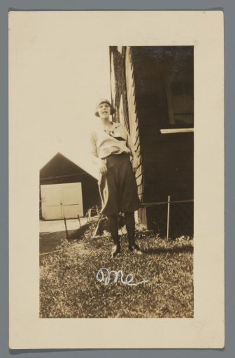 Woman standing by a house
