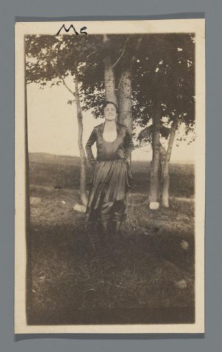 Woman standing before a tree
