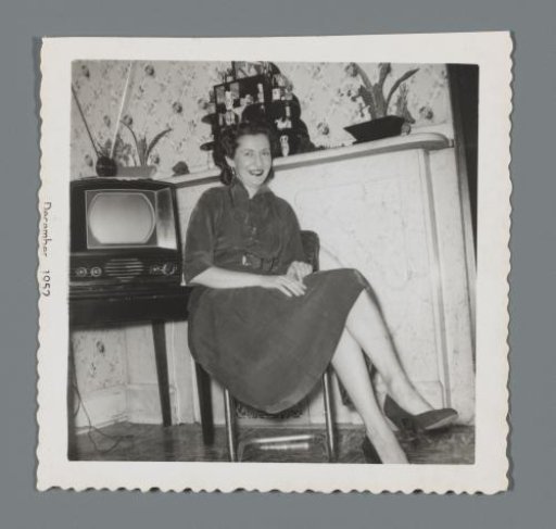 Woman seated by a television