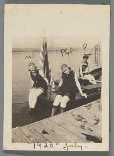 Portrait of two young women in bathing suits on the deck of the boat