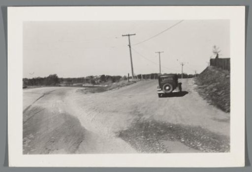 Photo from a car at a road junction, with another car in the foreground