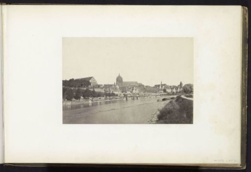 View of a town with a church on a river, probably Central Europe