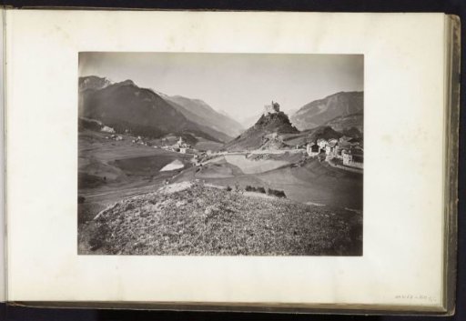 Valley with village and castle on a rock, presumably in the Alps