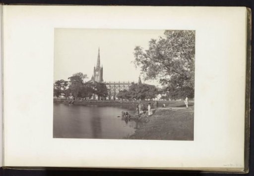 View of St. Paul's Cathedral with women by the water in the foreground, Kolkata, West Bengal, India