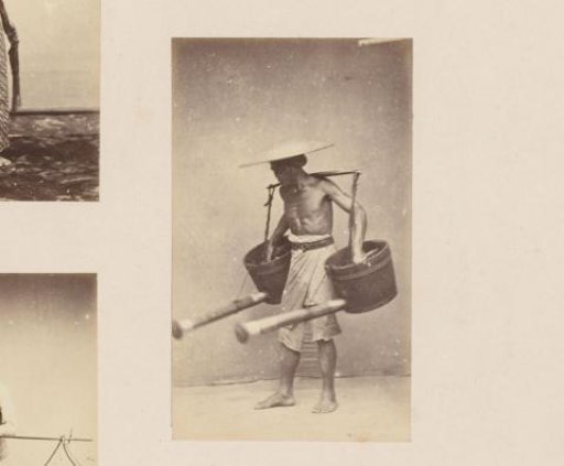 Portrait of an Indonesian man with two jugs on a carrying pole