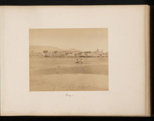 View of Suez with two crouching men in the foreground