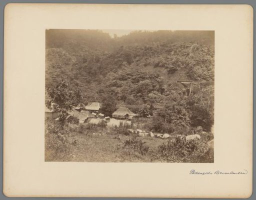 View of a village in a valley in West-Sumatra with part of a railway bridge on the right