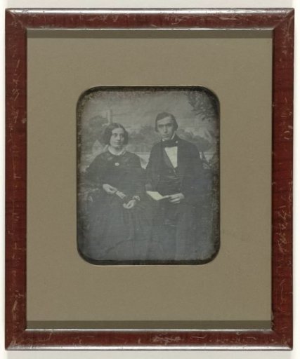 Portrait of an unknown man and woman before a painted city view