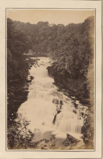 Seated man at the Stonebyres Falls
