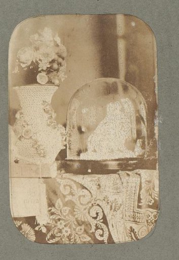Still life with a small copy of 'Ariadne auf dem Panther', a 'Snowball Vase', flowers and a book