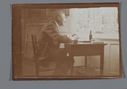 Willem Witsen at a desk in his boat