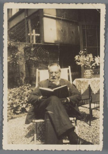 Portrait of an unknown man reading in the garden