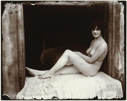 Portrait of an unknown naked woman in a window