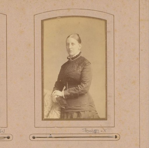 Portrait of a standing woman with a book in her hand