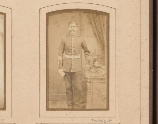 Portrait of a standing man in uniform, leaning on a balustrade