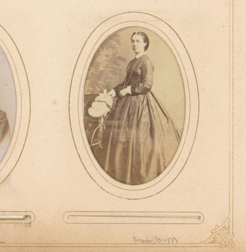 Portrait of a standing woman beside a chair