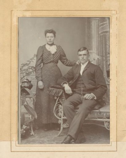 Portrait of a standing woman and a seated man