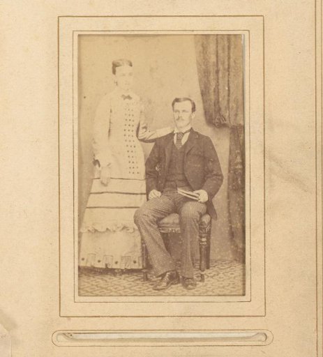 Portrait of a sitting man with a book in his hand and a standing woman