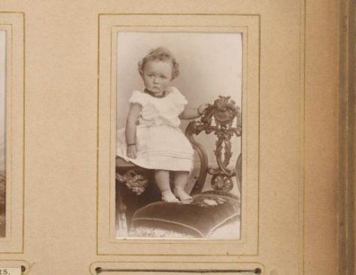 Portrait of a girl seated on a table