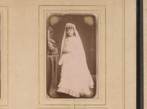 Portrait of a girl in a white dress, presumably for first communion