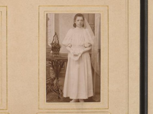 Portrait of a girl in a white dress, presumably for first communion