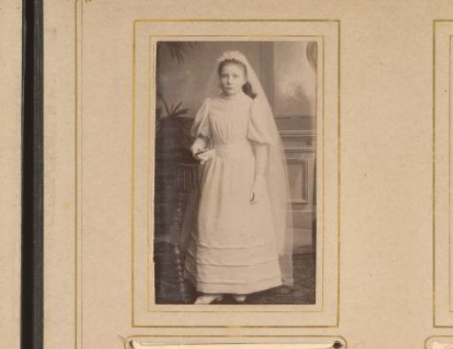 Portrait of a girl in a white dress, presumably for first communion