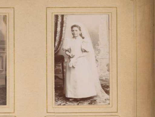 Portrait of a girl in a white dress, presumably for first communion