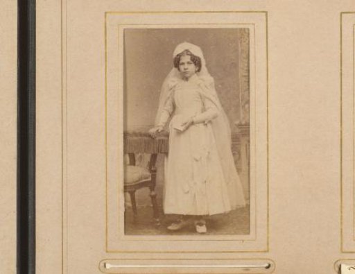Portrait of a girl in a white dress, presumably for first communion