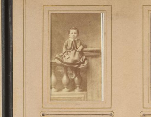 Portrait of a boy sitting on a balustrade