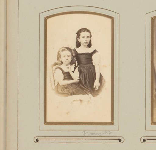 Portrait of two girls, one of whom seated on a chair