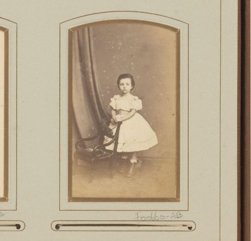 Portrait of a young girl, standing by a chair