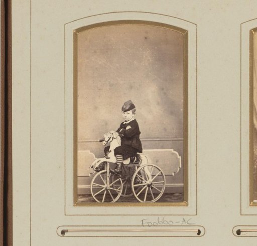 Portrait of a boy on a rocking horse with wheels