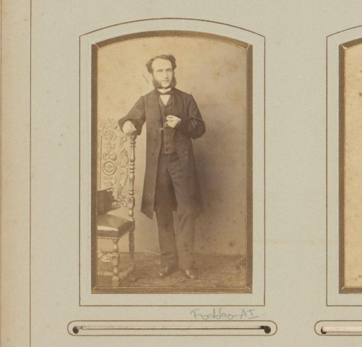 Portrait of a man, standing by a chair