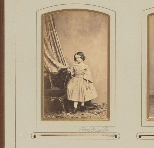 Portrait of a girl by a chair