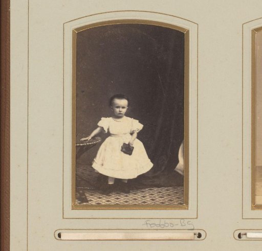 Portrait of a young girl by a table with book in hand
