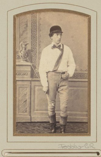 Portrait of a young man with cap, whip, bow tie and sash