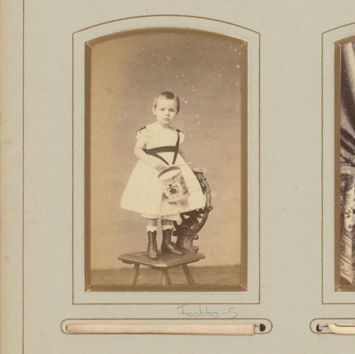 Portrait of a young girl with a drum on a chair