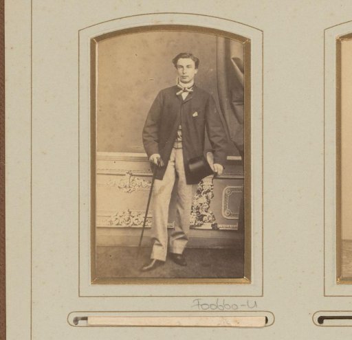 Portrait of a man with walking stick and hat in hand