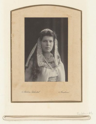 Portrait of a woman in Oriental costume with beads and embroidered ribbons