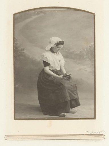 Portrait of a reading woman in Dutch national dress