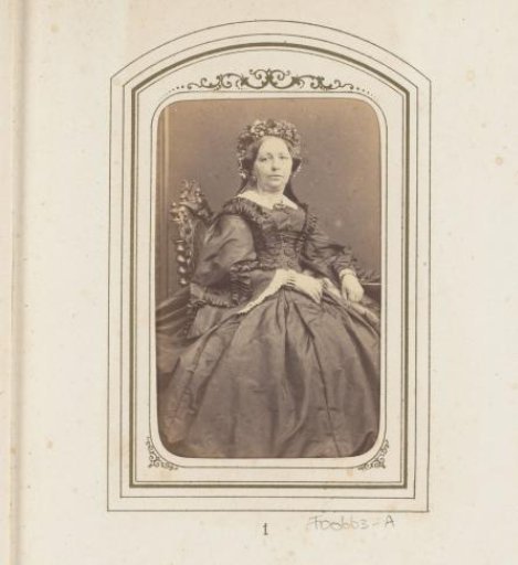 Portrait of a seated woman with a cap
