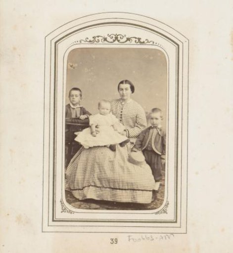 Family portrait of a mother in a piqué dress with three children