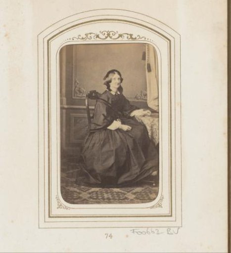 Portrait of a seated woman with a cap