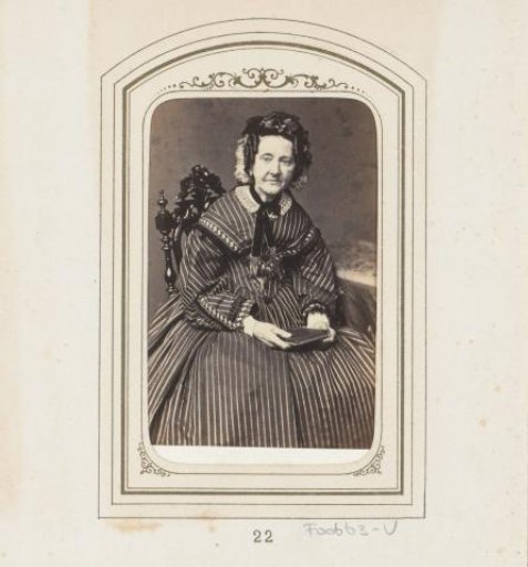 Portrait of a seated woman in a striped dress with a cap