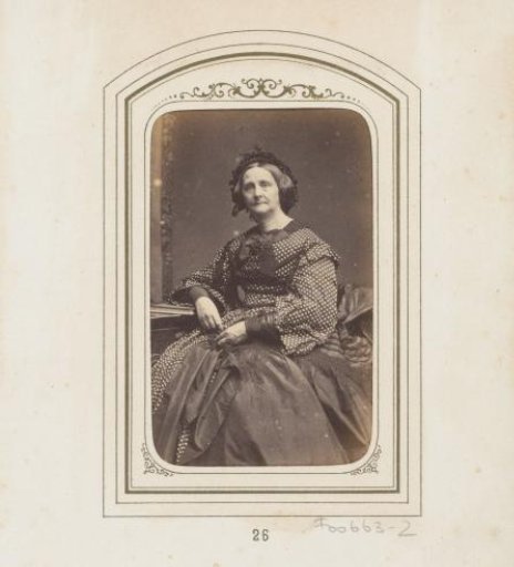 Portrait of a seated woman in a piqué dress