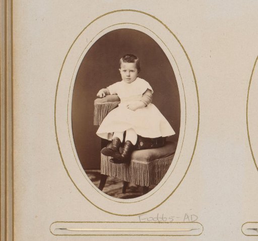 Portrait of a Child, Sitting on a Chair with a Suitcase