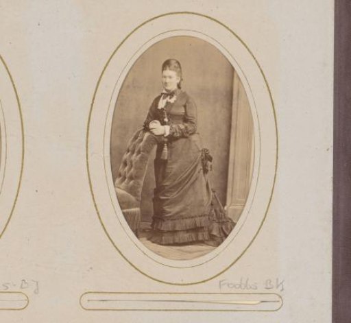 Portrait of a woman leaning on an armchair