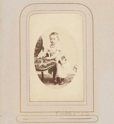 Portrait of a Boy with Bag and Toy Horse