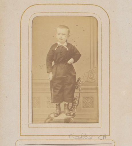 Portrait of a Little Boy Standing on a Chair