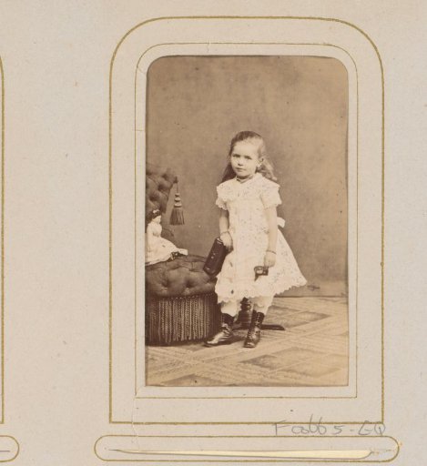 Portrait of a girl with a doll and a book
